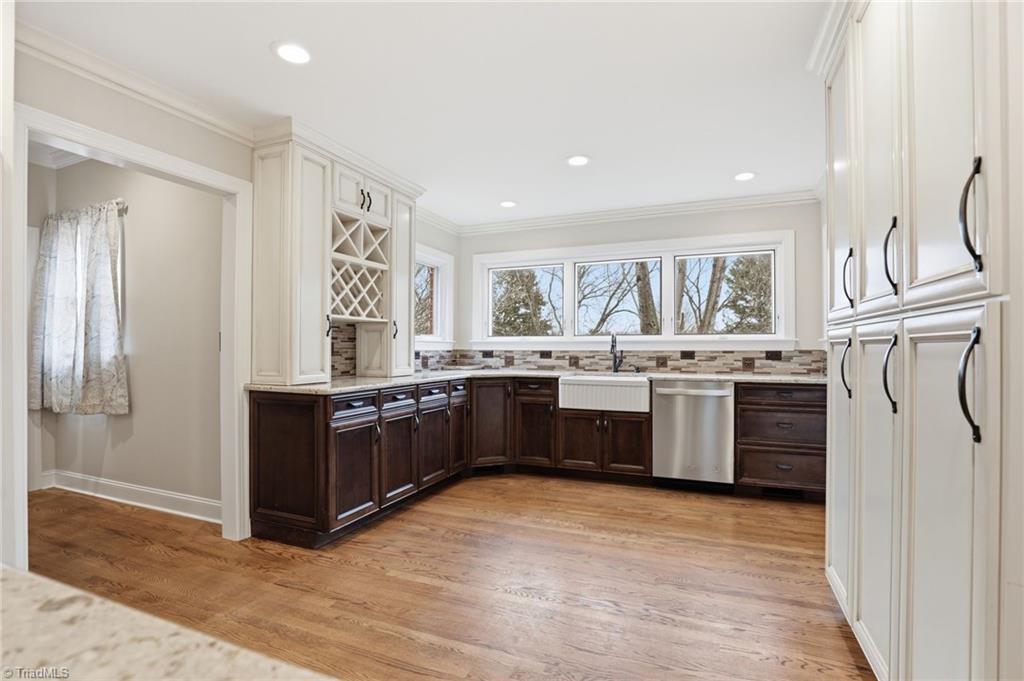 Image 3: Beautiful Windows allowing sunlight to fill the kitchen! Built-in cabinetry provides substantial storage for all your kitchen gadgets and supplies.
