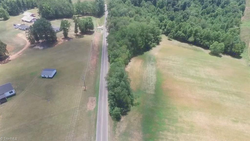 Image 2: Aerial view of wooded lot