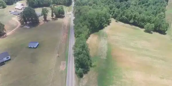 Image 2: Aerial view of wooded lot