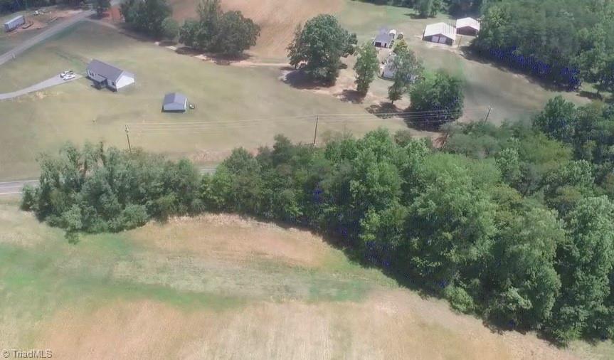 Image 3: Aerial view of wooded lot