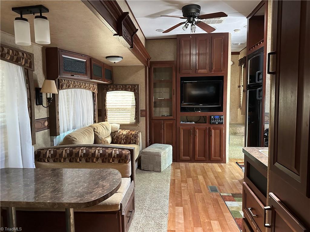 Image 2: Interior of RV Features kitchen/living area