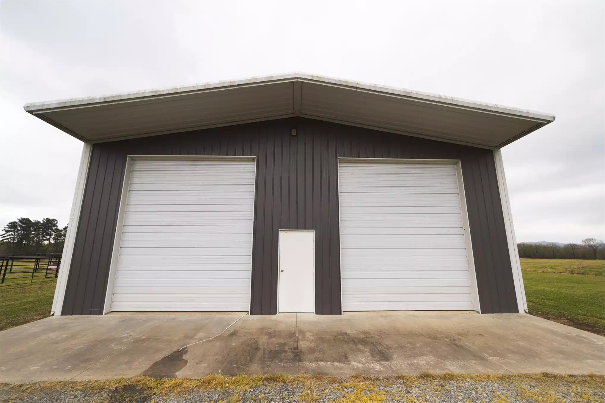 Image 1: Metal structure featuring a broad concrete apron,