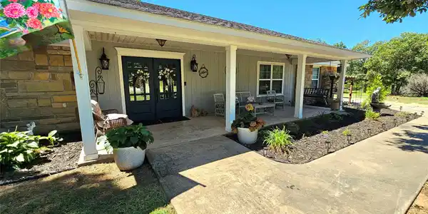 Image 3: Inviting covered front porch with stone facade acc