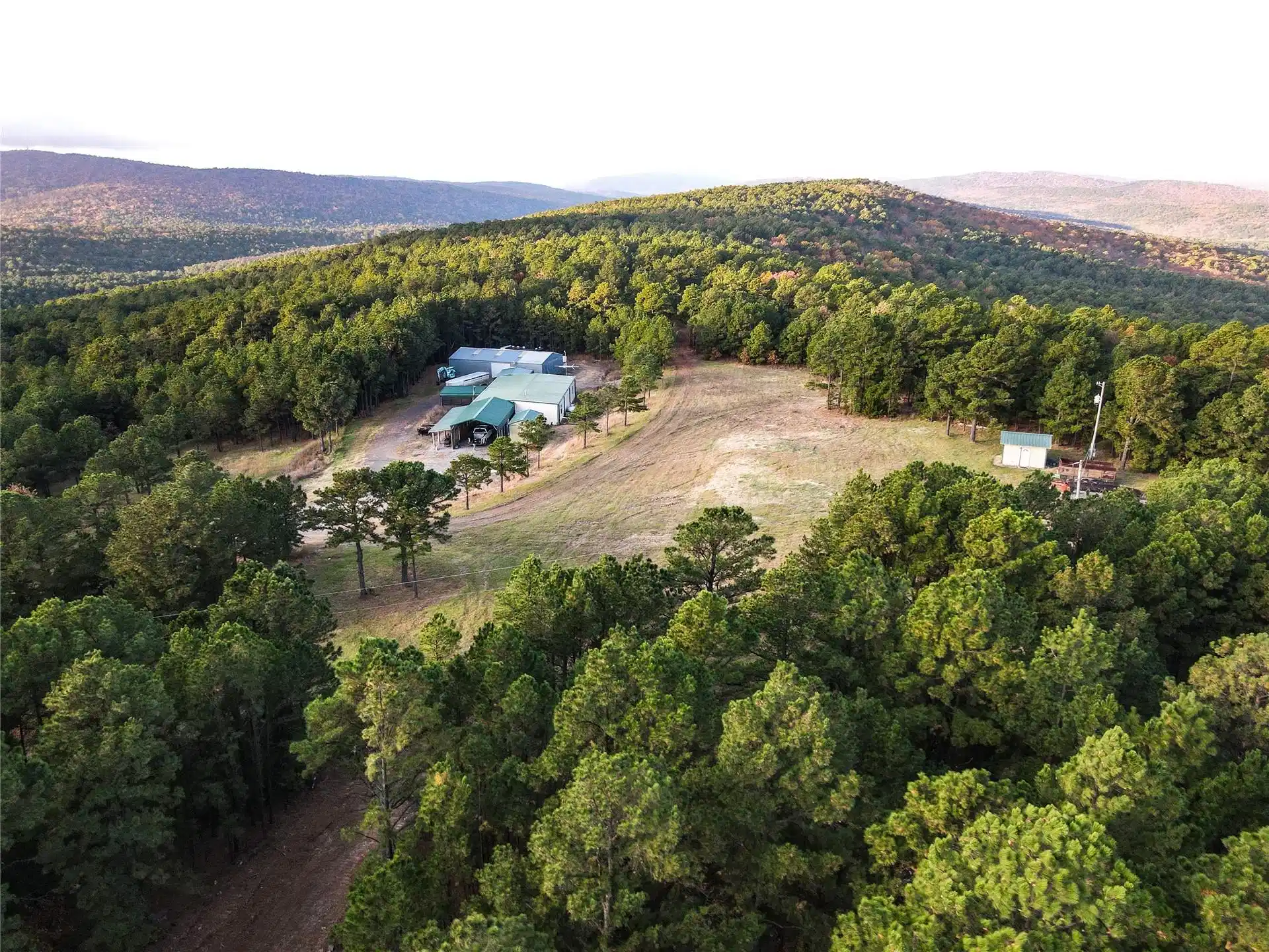 Image 1: Expansive forested landscape with multiple structu