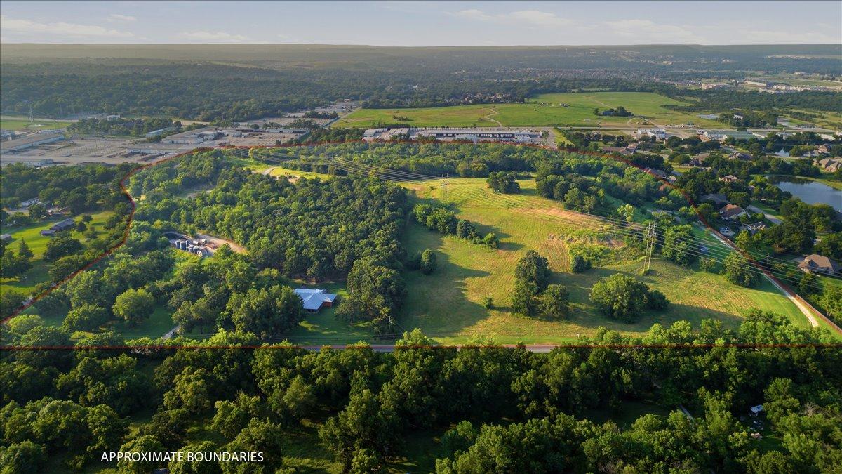 Image 1: Expansive acreage featuring a mix of mature tree c
