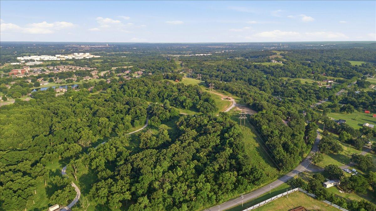 Image 4: Expansive wooded acreage featuring rolling terrain