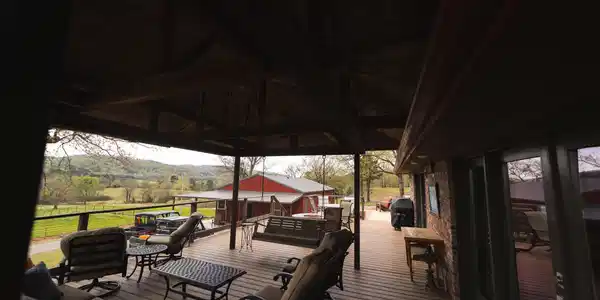 Image 3: Expansive covered deck featuring wood-finish floor