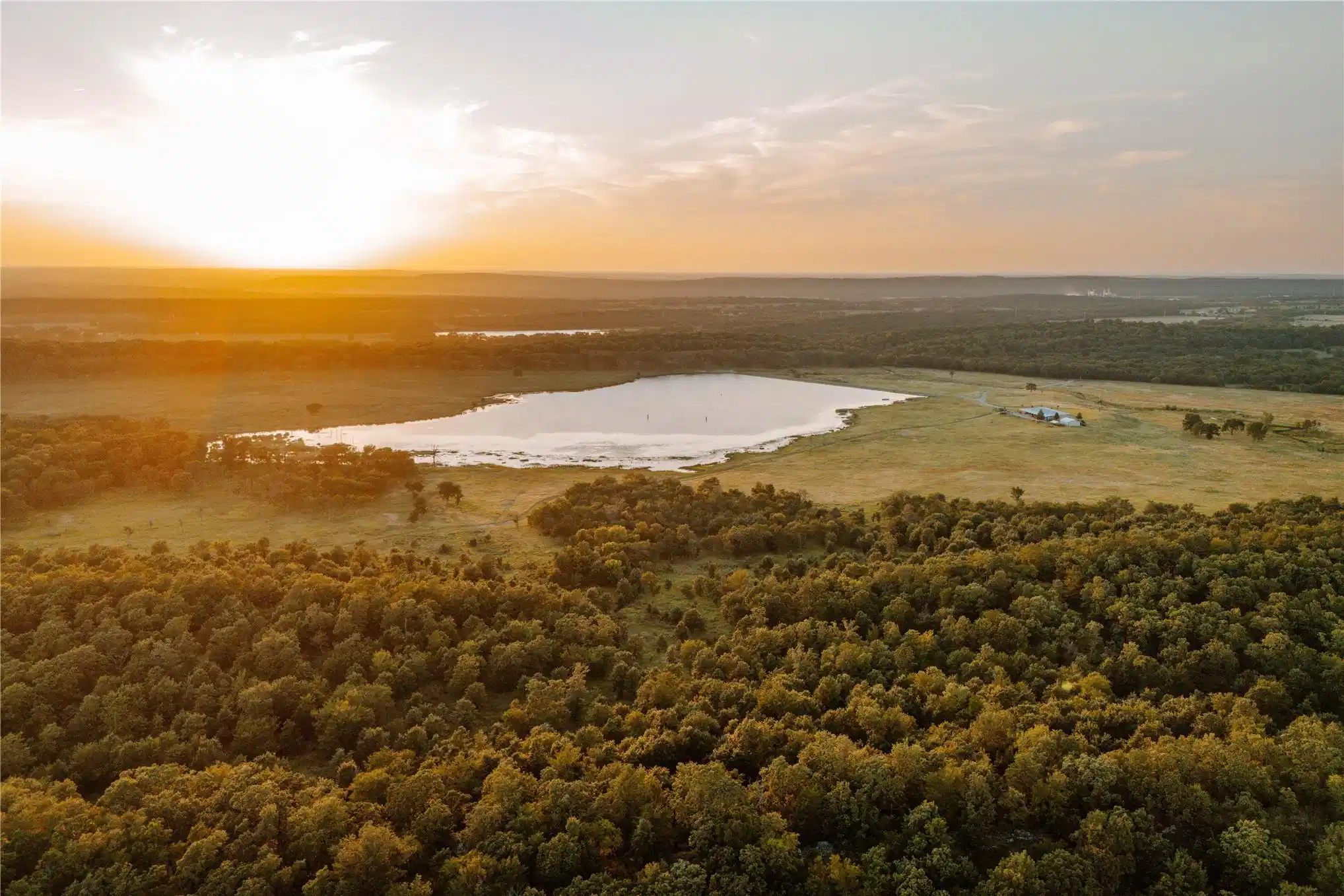 Image 1: Expansive acreage featuring a substantial body of