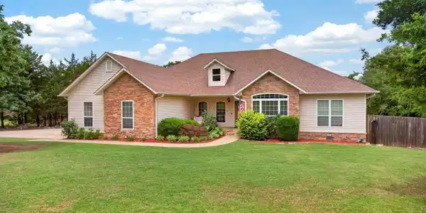 Image 3: Ranch-style exterior with stone and siding accents