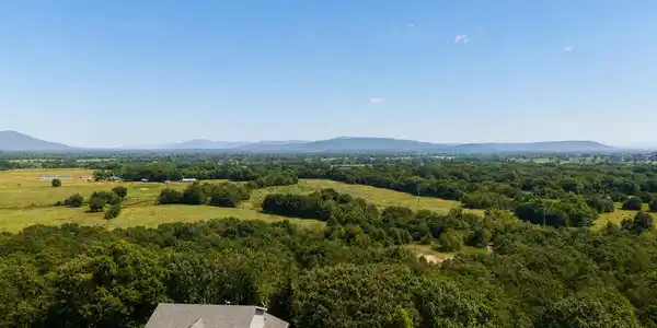 Image 3: Expansive property featuring a grey two-story resi