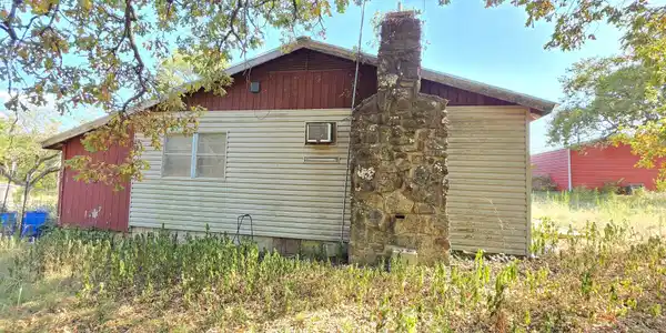 Image 4: Stone chimney with a wood-paneled and horizontal s