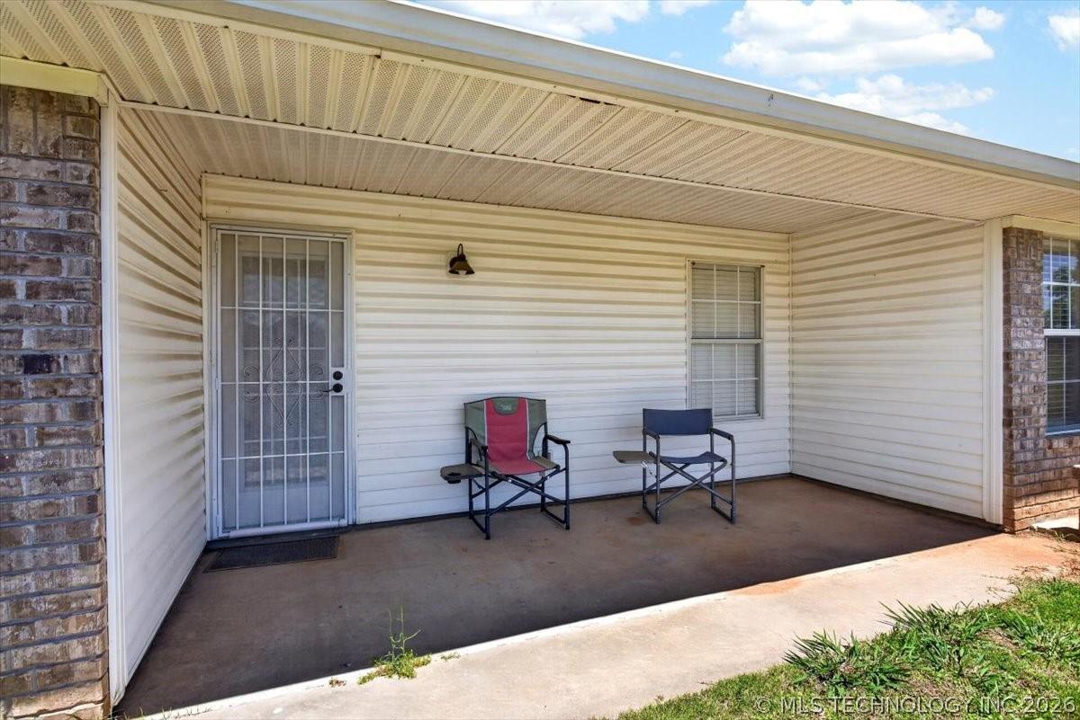 Image 4: Covered porch featuring a concrete slab, white vin