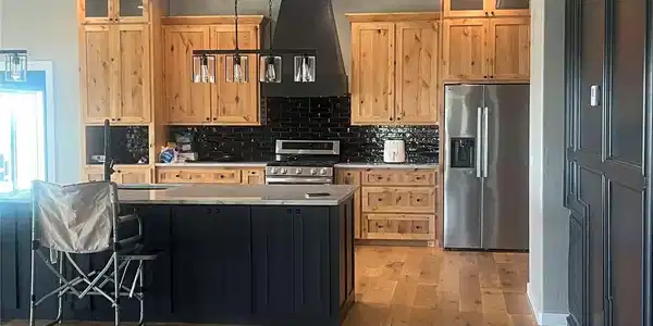 Image 2: Kitchen featuring wood-finish flooring, a dark-ton