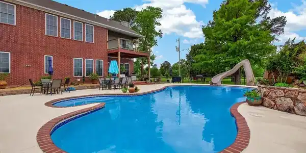 Image 4: Expansive free-form pool with integrated spa and b