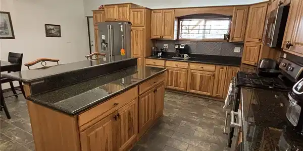 Image 4: Kitchen featuring an expansive island with storage