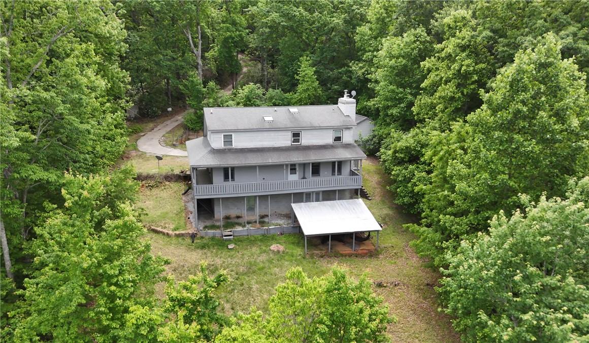 Image 2: Perched among lush greenery, this home offers tran