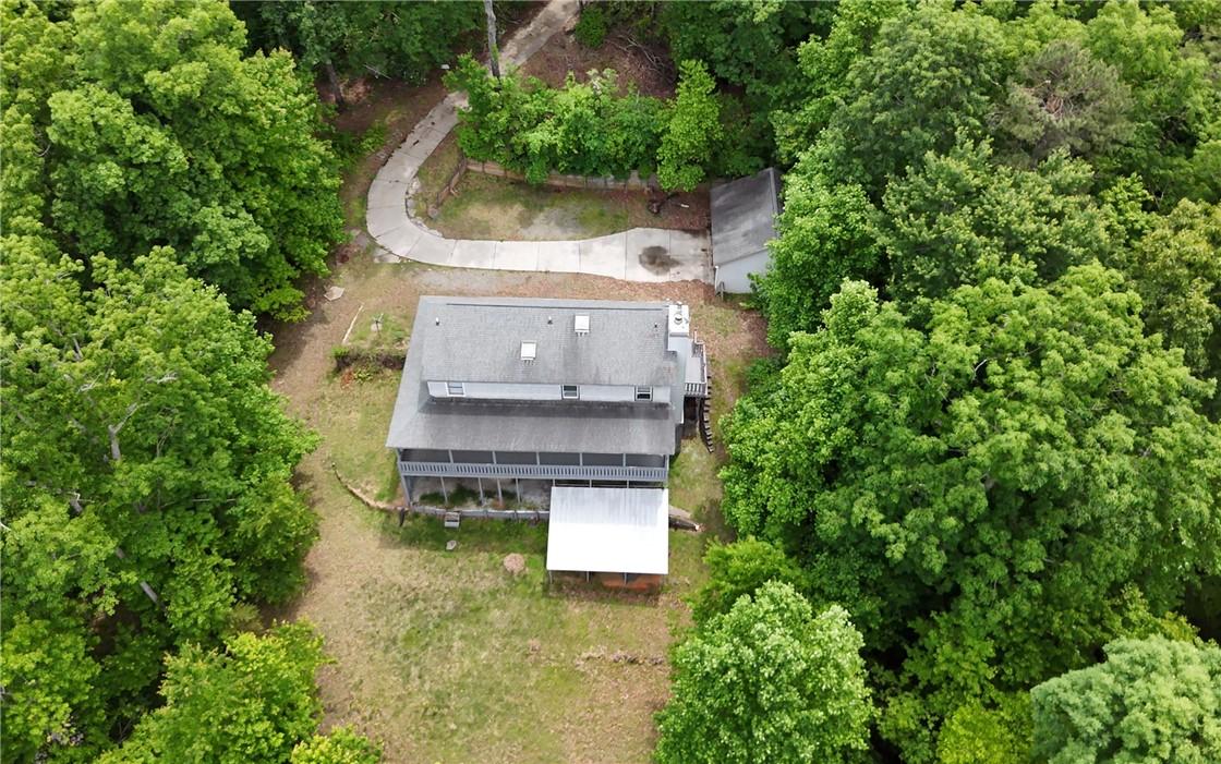 Image 4: Perched amidst lush greenery, this home offers ser