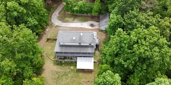Image 4: Perched amidst lush greenery, this home offers ser