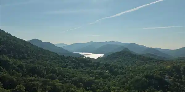 Image 2: A captivating panorama unfolds with verdant mounta