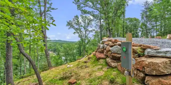 Image 2: A verdant hillside property offers commanding view