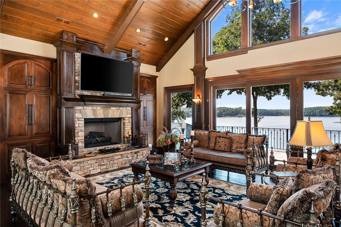Image 3: A spacious living area with soaring wood-beamed ce
