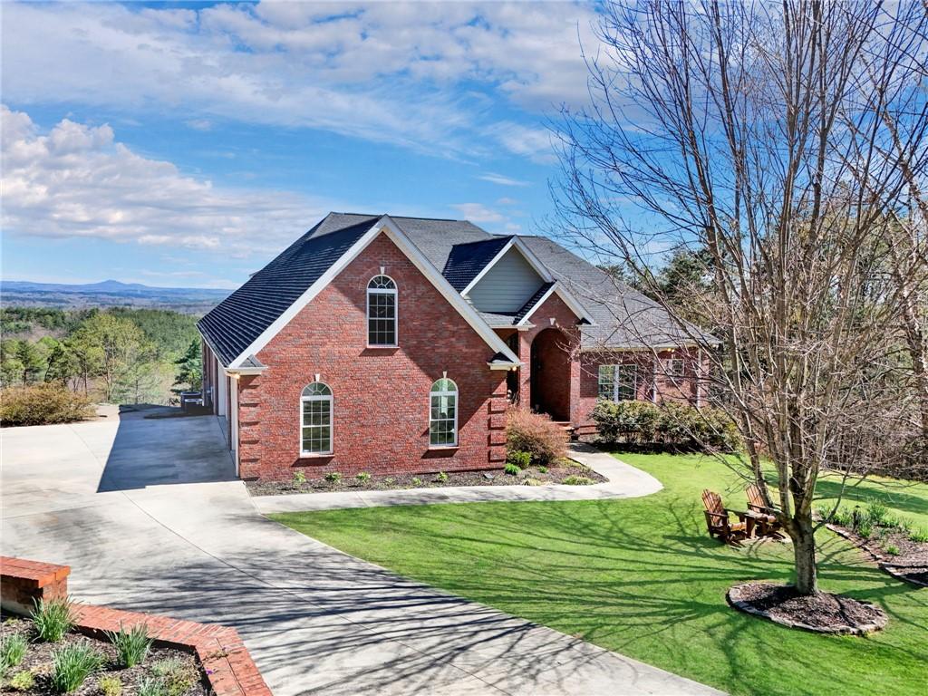 Image 1: This brick home offers serene mountain views.