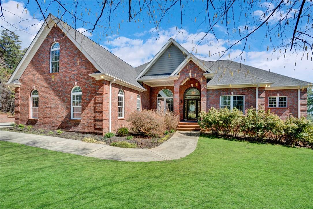 Image 2: This classic brick residence features an inviting