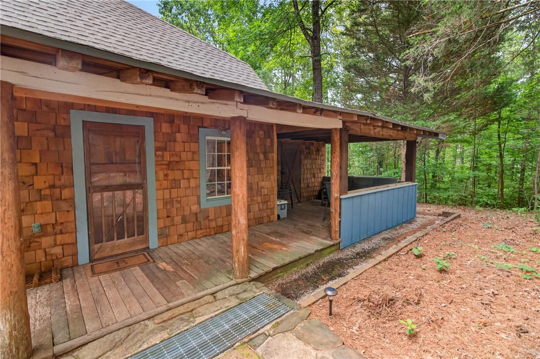 Image 2: A charming rustic retreat with a covered front por