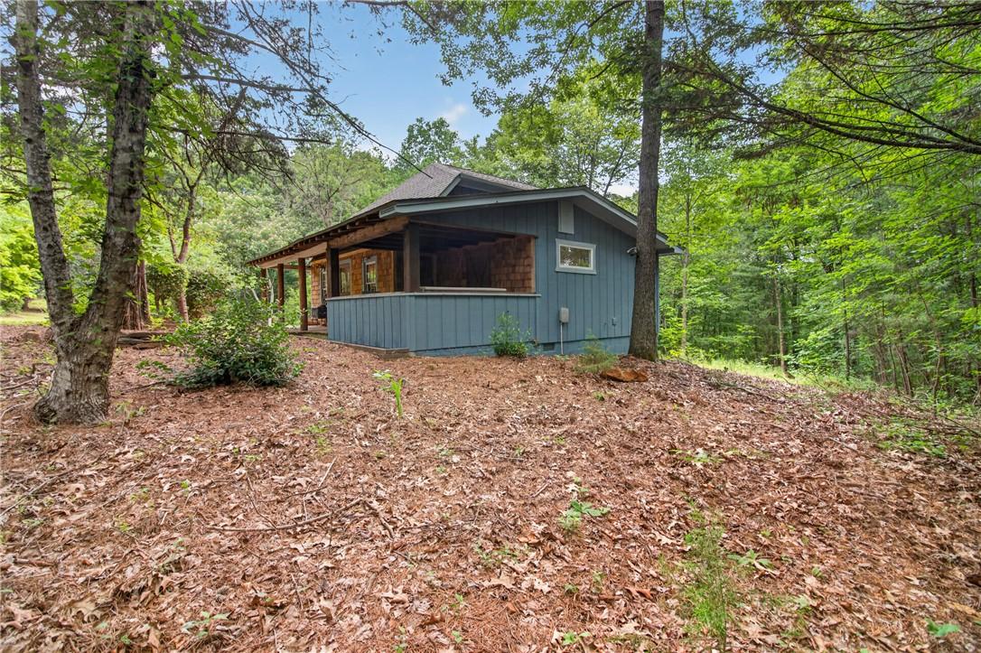 Image 4: A tranquil woodland retreat, this home offers natu