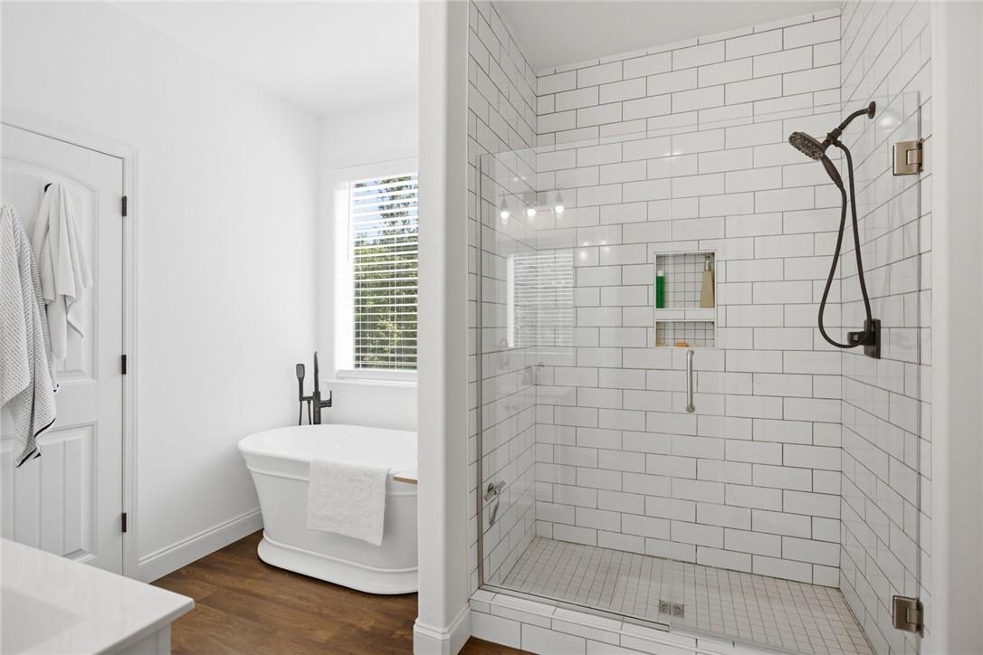 Image 4: This serene bathroom offers a classic freestanding
