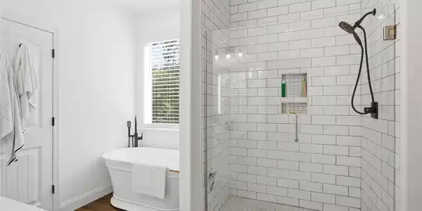 Image 4: This serene bathroom offers a classic freestanding