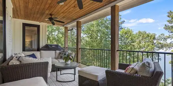 Image 3: An inviting covered deck offers serene lake views