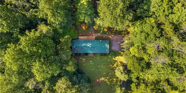 Image 2: A secluded residence rests enveloped by mature woo