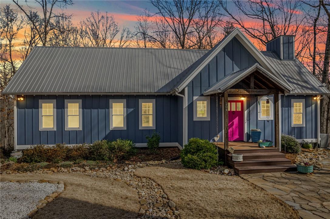 Image 3: This charming home offers a striking facade with a