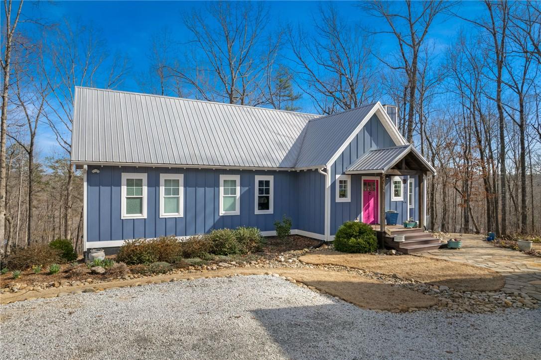 Image 4: This charming home offers a striking facade, frame