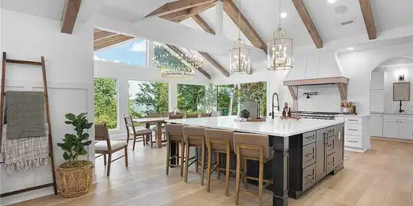 Image 2: Exposed wood beams frame a spacious kitchen under