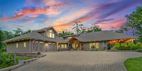 Image 2: A grand fa&ccedil;ade with an expansive paver driveway we