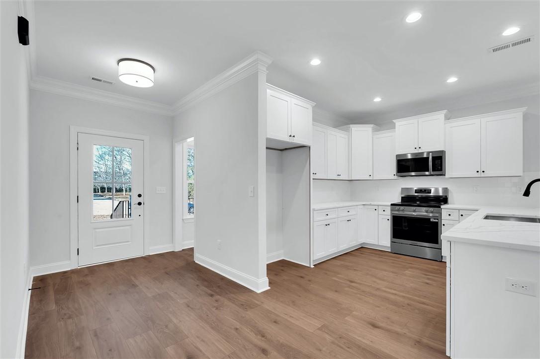 Image 3: This bright kitchen and entry area offers contempo
