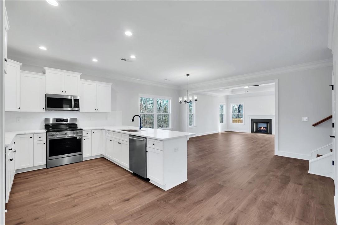 Image 4: This bright and airy open-concept space features a