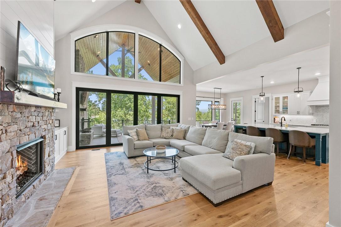 Image 4: A spacious great room boasts soaring vaulted ceili