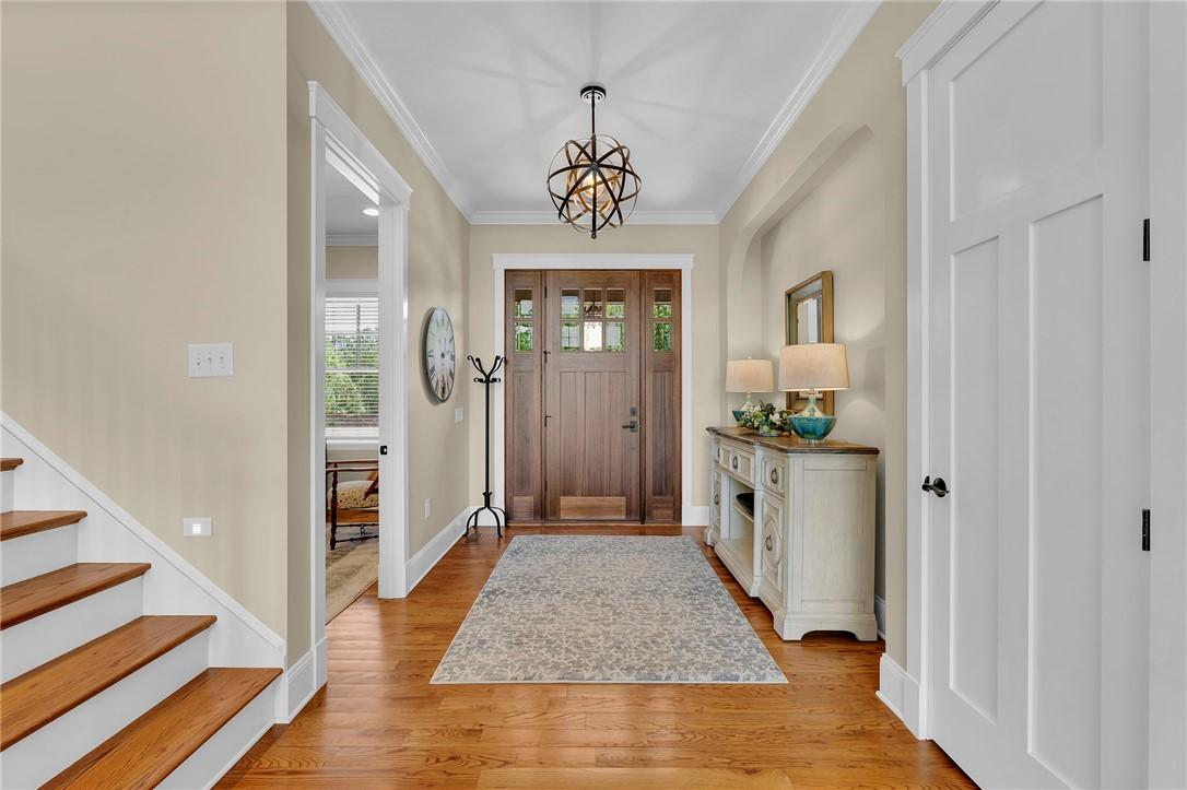 Image 3: Enter into a welcoming foyer featuring rich hardwo