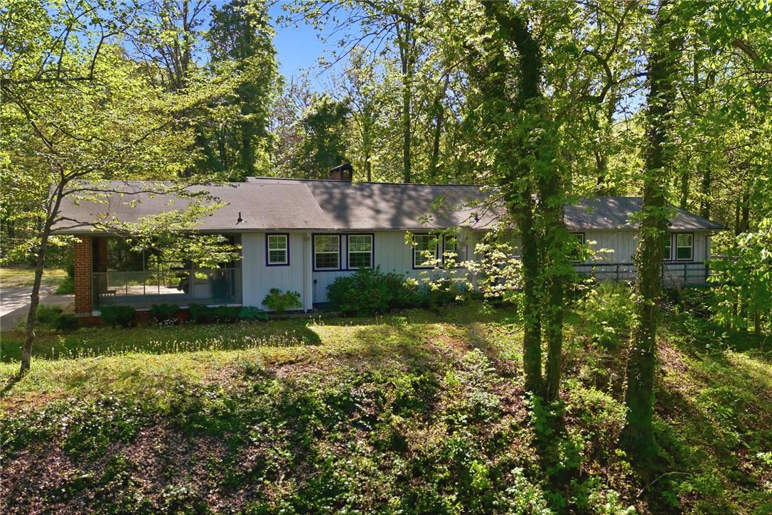 Image 2: This secluded residence, nestled among vibrant tre