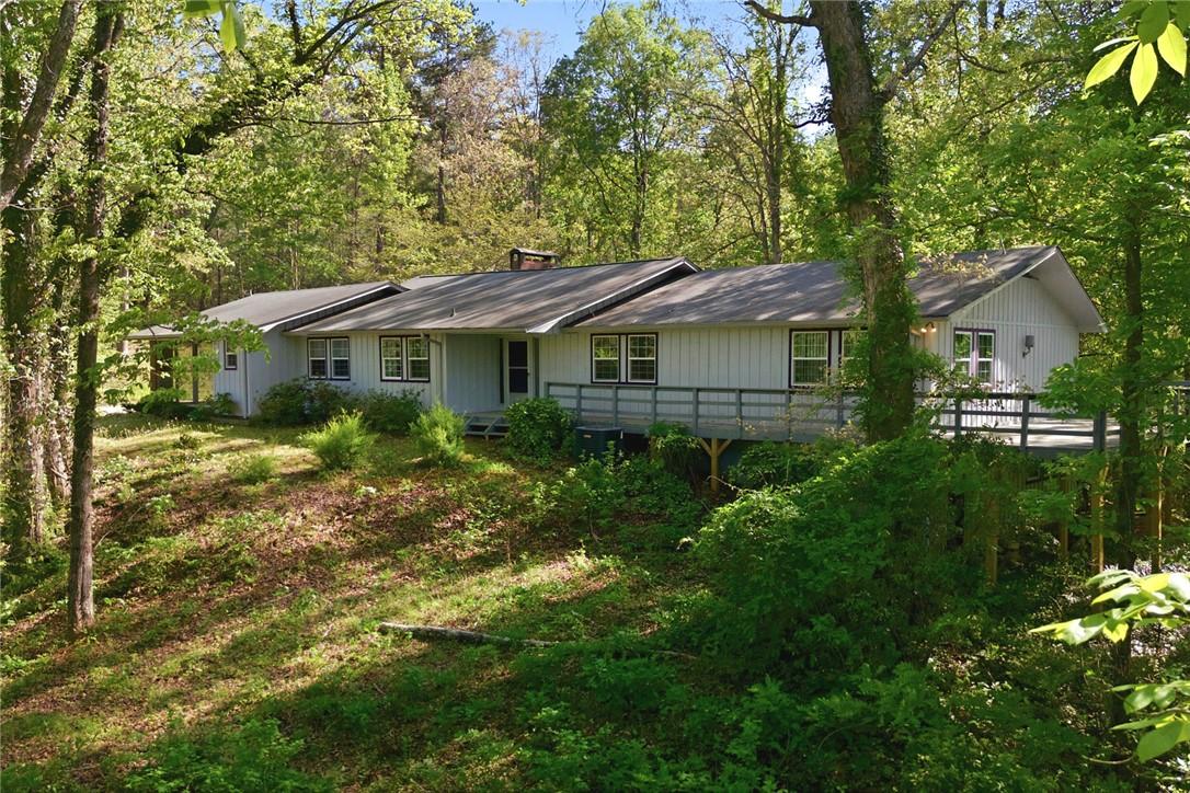 Image 3: This private, wooded retreat features a spacious d