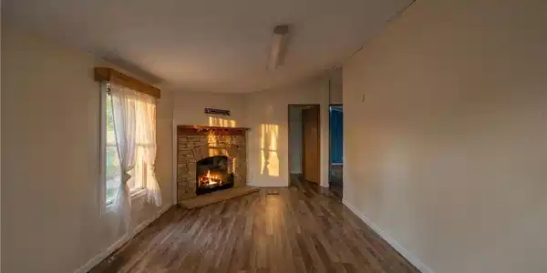 Image 3: Rich wood-textured flooring flows toward a classic