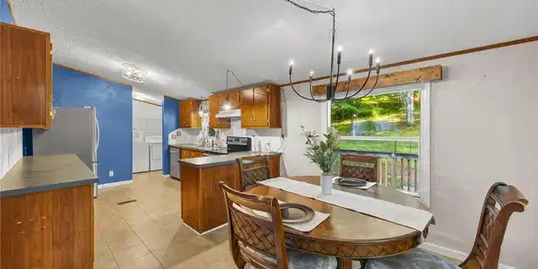 Image 4: An open dining area flows into the kitchen with wo