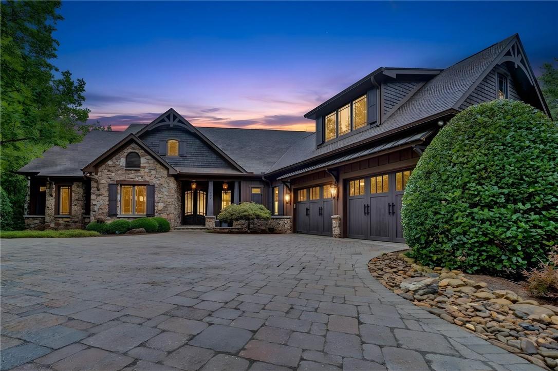 Image 1: A grand stone and wood facade welcomes you, set ag
