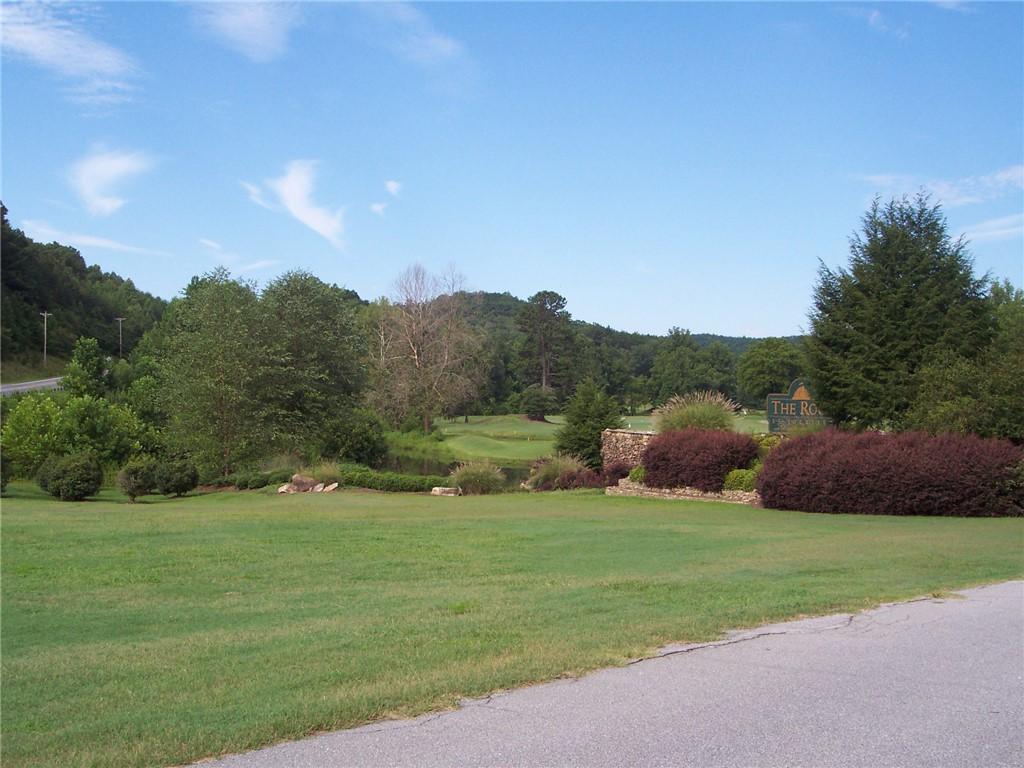 Image 2: Lush greens and mature trees define this picturesq