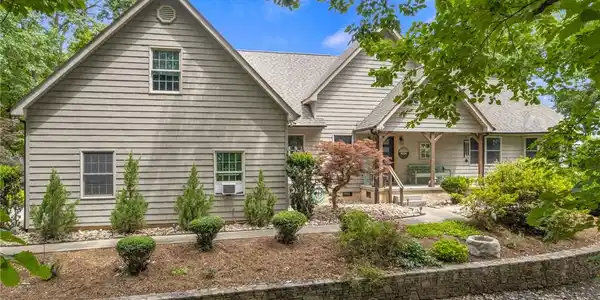 Image 4: A welcoming front porch and well-maintained landsc