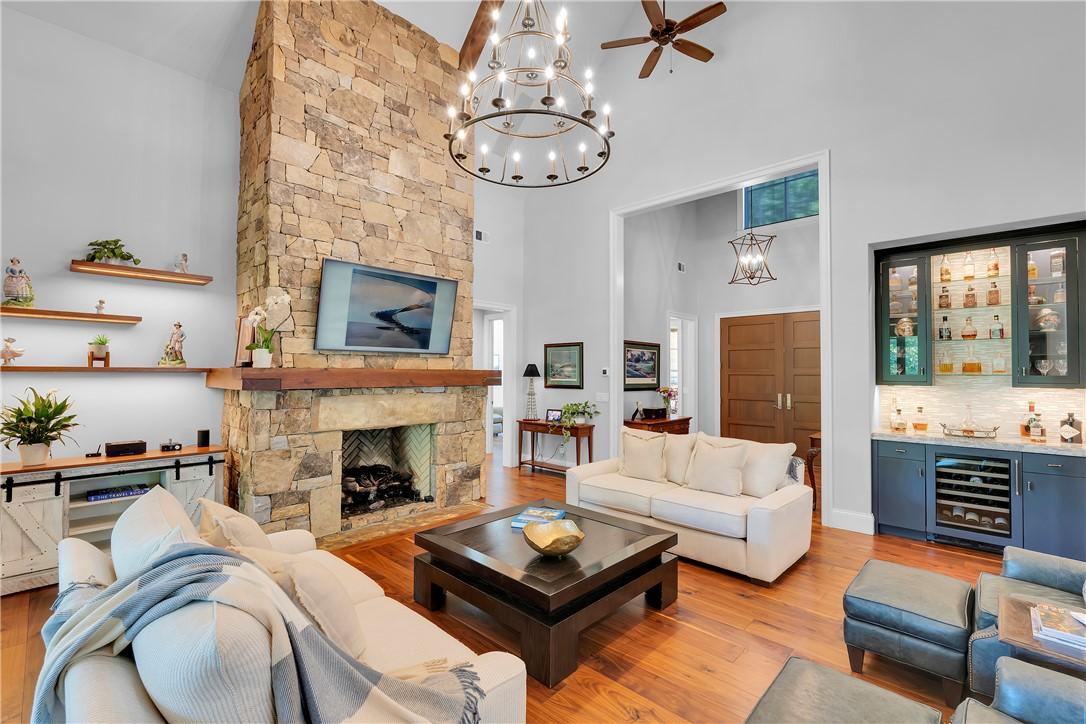 Image 4: An inviting great room with soaring ceilings, a st