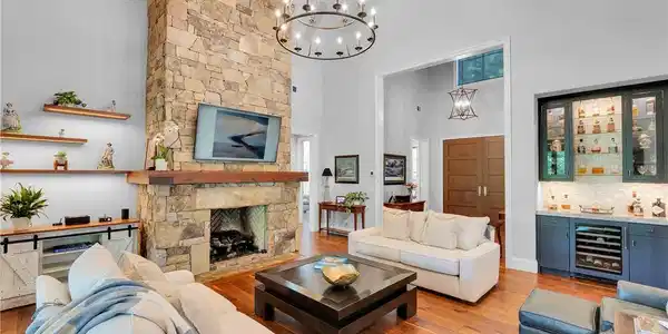 Image 4: An inviting great room with soaring ceilings, a st
